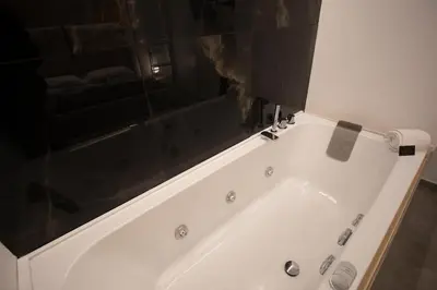 a white bath tub in a bathroom with a mirror at LUXURY SUITE SANT ISIDORO in Palermo