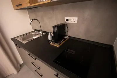 a kitchen counter with a sink and a microwave at LUXURY SUITE SANT ISIDORO in Palermo