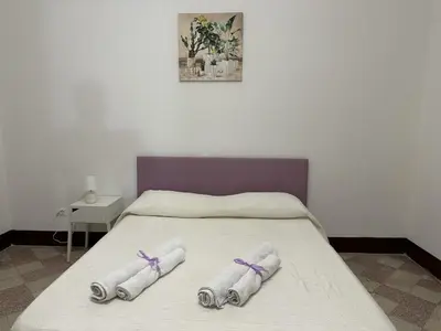 a bedroom with two towels on a bed at Le stanze di Regina Margherita in Palermo