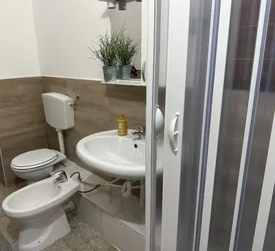 a bathroom with a toilet and a sink at Le stanze di Regina Margherita in Palermo