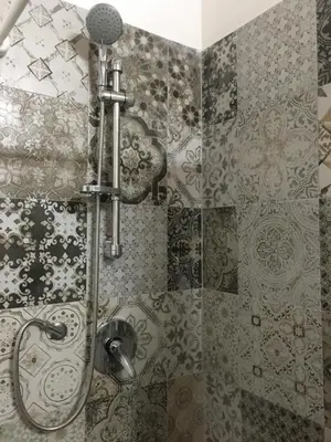 a shower in a bathroom with tiles on the wall at Le stanze di Regina Margherita in Palermo