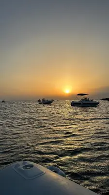 a group of boats in the water at sunset at Le stanze di Regina Margherita in Palermo