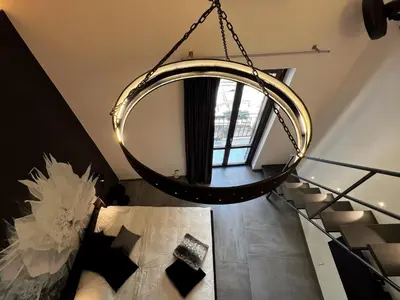 a chandelier hanging from the ceiling in a room at Sant'Andrea - Luxury Rooms in Vucciria in Palermo