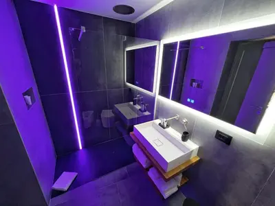 a purple bathroom with a sink and a mirror at Sant'Andrea - Luxury Rooms in Vucciria in Palermo