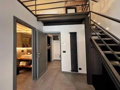 a hallway with a staircase in a house at Sant'Andrea - Luxury Rooms in Vucciria in Palermo