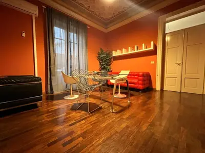 a living room with a table and chairs and a couch at 38,VELASQUEZ in Palermo