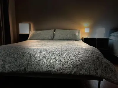 a bedroom with a bed with a black and white comforter at 38,VELASQUEZ in Palermo