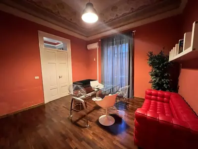 a living room with a red couch and a table at 38,VELASQUEZ in Palermo