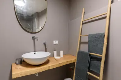a bathroom with a bowl sink and a mirror at Suite Gharraf Palermo Old Town in Palermo
