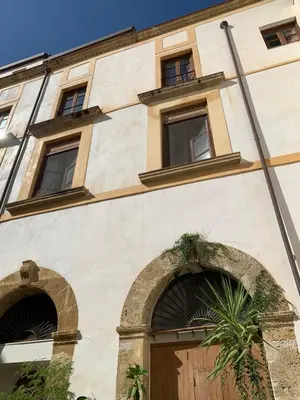 a building with two windows and a door at Palazzo resuttana in Palermo