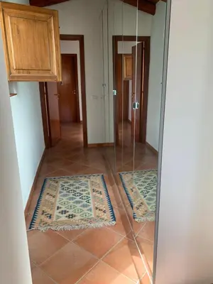 a room with two rugs on the floor and a mirror at Palazzo resuttana in Palermo