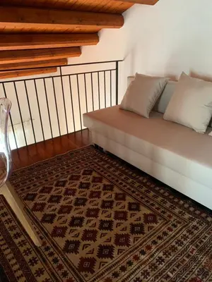 a bed in a room with a rug at Palazzo resuttana in Palermo