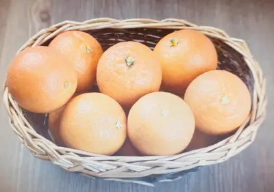 a bunch of oranges in a basket on a table at Hola House al Capo in Palermo
