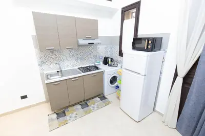 a small kitchen with a stove and a refrigerator at Piave77 in Bagheria