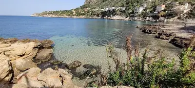 a view of a beach with rocks and the water at Piave77 in Bagheria
