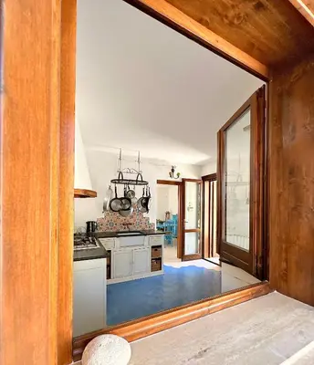 a kitchen with a large glass door leading into a room at Stunning Seafront Villa in Scopello Pool & Jacuzzi in Scopello