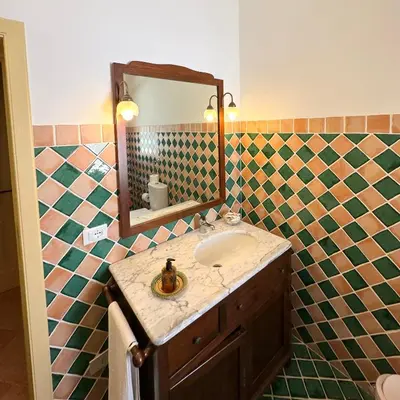 a bathroom with a sink and a mirror at Stunning Seafront Villa in Scopello Pool & Jacuzzi in Scopello