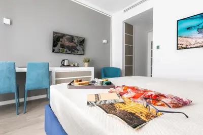 a bedroom with a bed with a tray of food on it at La Musa Apartments & Rooms in Palermo