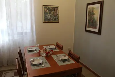a dining room table with chairs and a table and a table at Himera Holiday in Palermo