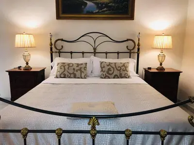 a bedroom with a large bed with two lamps at B&B Al Piazza Marina in Palermo