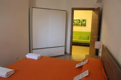 a bedroom with a bed with two price tags on it at Ideal Residence & SPA in Alcamo