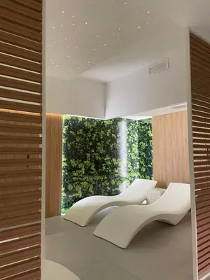 a room with white chairs and a large window at Ideal Residence & SPA in Alcamo