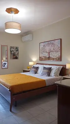 a bedroom with a large bed in a room at Lorenzo Guest Suite - Garage privato in Palermo