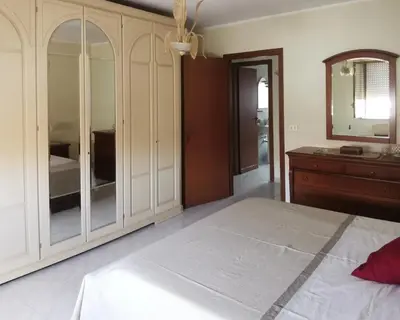 a bedroom with a bed and a dresser and a mirror at Lorenzo Guest Suite - Garage privato in Palermo