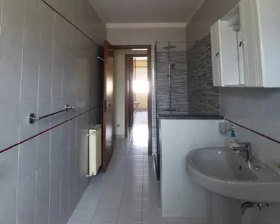 a bathroom with a sink and a toilet and a mirror at Lorenzo Guest Suite - Garage privato in Palermo