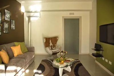 a living room with a couch and a table at La Conchiglia Case Vacanze in Balestrate