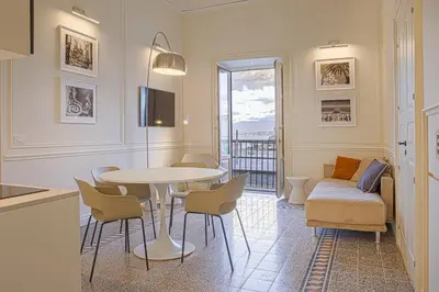 a living room with a table and a couch at Costamante Suites & Spa in Castellammare del Golfo