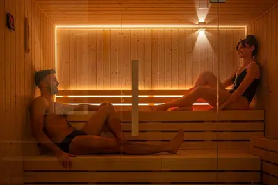 a man and woman sitting in a sauna at Costamante Suites & Spa in Castellammare del Golfo