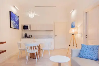 a living room with a couch and a table at Costamante Suites & Spa in Castellammare del Golfo