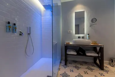 a bathroom with a sink and a shower at Costamante Suites & Spa in Castellammare del Golfo