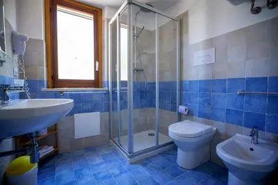 a bathroom with a toilet and a sink and a shower at Casale la Macina Residence Scopello in Scopello