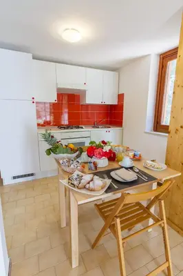 a kitchen with a table with food on it at Casale la Macina Residence Scopello in Scopello