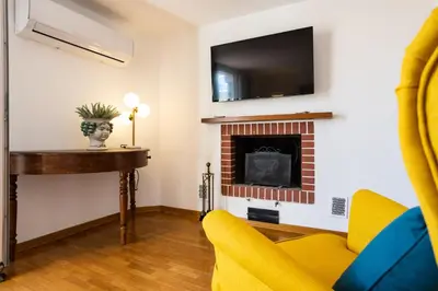 a living room with a fireplace and a tv at Politeama rooftop in Palermo