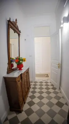 a bathroom with a mirror and a checkered floor at Petrarca Suite in Palermo