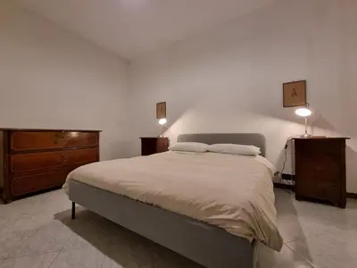a bedroom with a large bed and two night stands at Piazza Politeama in Palermo
