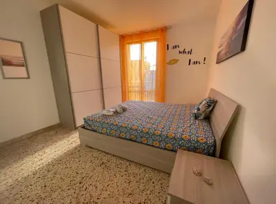 a small bedroom with a bed and a window at Appartamento Ponente in Balestrate
