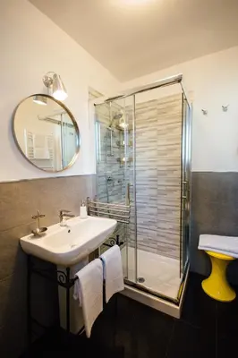 a bathroom with a sink and a shower at Bed à Cala in Palermo