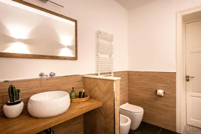 a bathroom with a sink and a toilet and a mirror at Crispi Apartments in Palermo