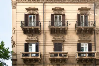 a building with windows and balconies on it at Crispi Apartments in Palermo
