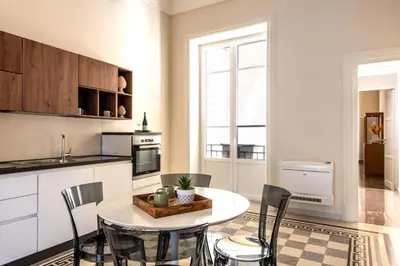 a kitchen with a table and chairs in a room at Crispi Apartments in Palermo
