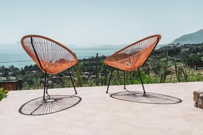 two orange chairs sitting on top of a table at Alla Riserva - Villa Riserva dello Zingaro - Scopello in Scopello