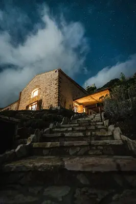 a stone house at night with stairs leading up to it at Alla Riserva - Villa Riserva dello Zingaro - Scopello in Scopello