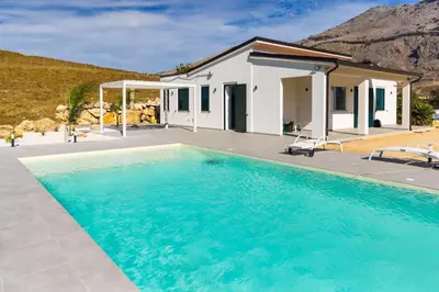 a swimming pool in front of a house at Villa Balata mare e relax in Balata di Baida