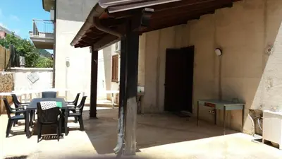 a large green couch sitting in a living room at appartamento in villa splendente in Castellammare del Golfo