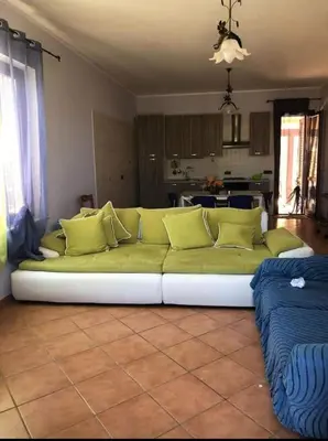 a living room with a couch and a window at appartamento in villa splendente in Castellammare del Golfo