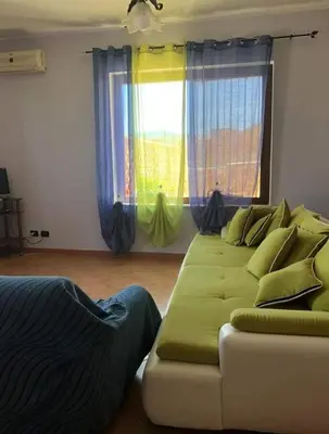 a bed in a room with a blue blanket at appartamento in villa splendente in Castellammare del Golfo
